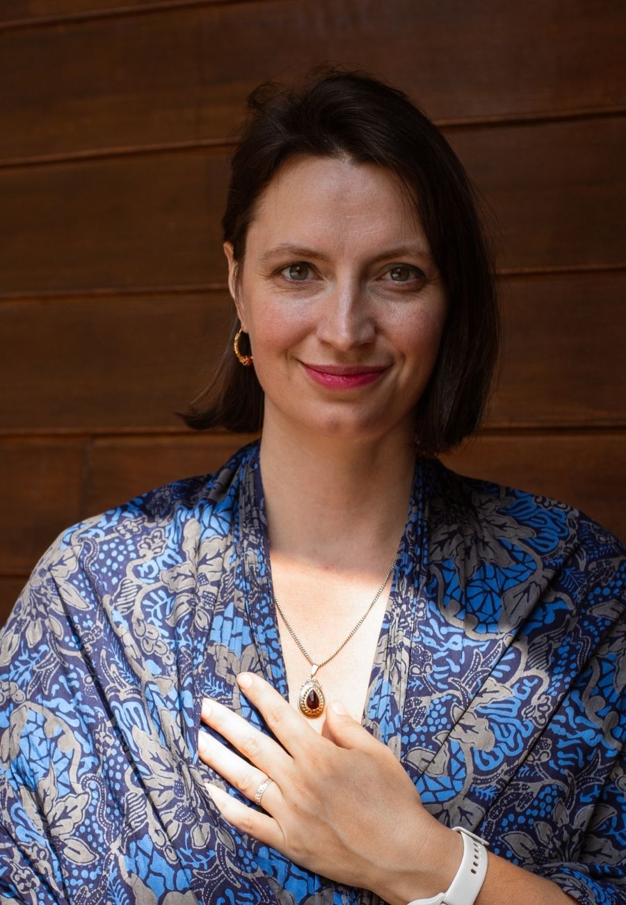 Inge, looking at you with a steady smile, hand resting at her heart